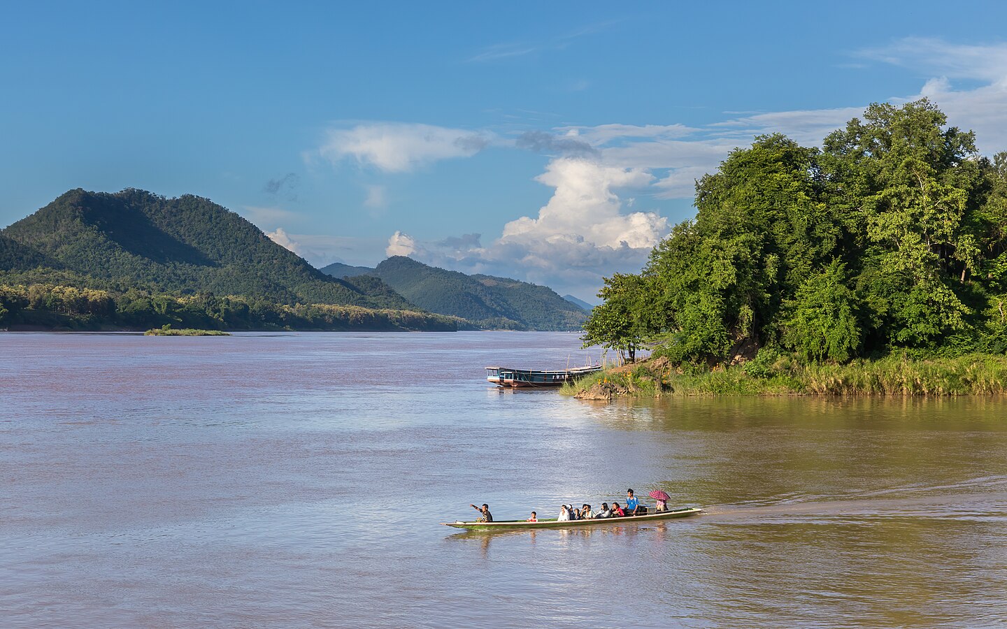 Pirogue running from the Nam Khan river to the Mekong a sunny day in Luang Prabang Laos
