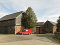 Residential stable house with attached side building, barn, side building and gate entrance to a four-sided courtyard