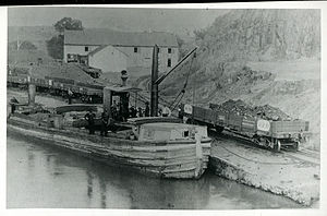 A steamboat on the C&O Canal. Note the steering wheel and the smokestack on this boat
