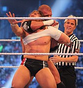Triple H traps Daniel Bryan in a crossface chickenwing Triple H uses a crossface chickenwing at WM30.jpg