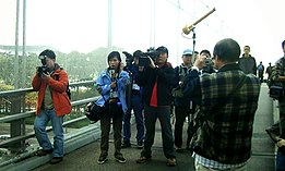 TVB reporter Joyce Fung and the station's photographers, shown covering the 2005 WTO protests in Hong Kong. Tvbnews wtoprotest.JPG