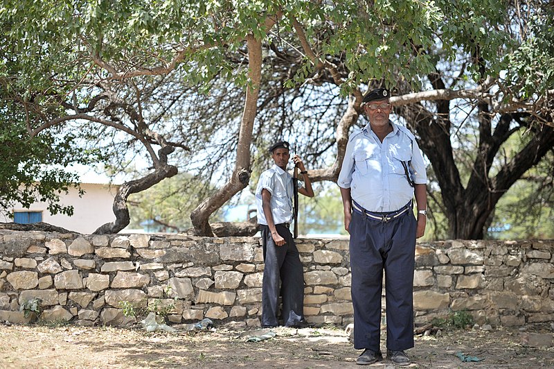 File:Two policemen stand inside the compound of Baidoa's Central Police Station in Somalia on June 20. AMISOM Photo - Tobin Jones (14281138397).jpg