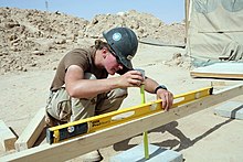 Level tool being used to establish horizontality. US Navy 080606-N-9623R-414 Builder 2nd Class Kathryn Henderson, assigned to Naval Mobile Construction Battalion (NMCB) 3, uses a horizontal level and tape measure.jpg