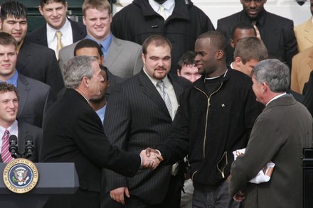Young at the White House with George W. Bush, Mack Brown, and members of the 2005 national championship team
