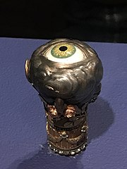 Knob of a walking stick with depictions of the senses