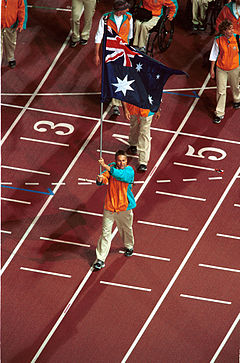 201000 - Opening Ceremony swimmer Brendan Burkett flag 3 - 3b - 2000 Sydney opening ceremony photo.jpg