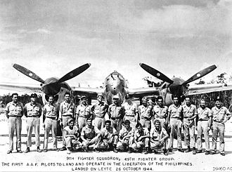 9th Fighter Squadron in front of a P-38 Lightning during the Battle of Leyte in October 1944. 9th Fighter Squadron - P-38 Mustang.jpg