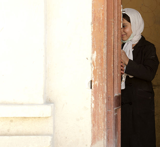 File:A shy Afghan school girl waits behind a door (5063731379).jpg