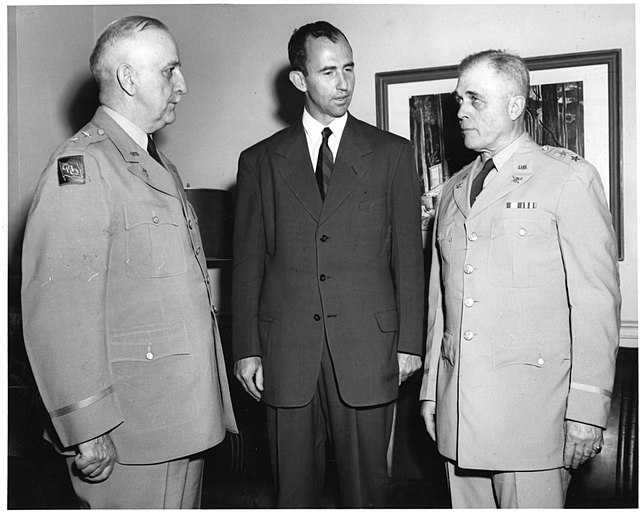 Army Secretary Frank Pace congratulates Generals Roy H. Parker and Louis Craig upon their retirements.