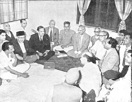 1965 photo-print of an informal gathering of poets/writers at the residence of Zia Fatehabadi. Seen left to right: Naresh Kumar Shad, Kailash Chander Naaz, Talib Dehalvi, Khushtar Girami, Balraj Hairat, Saghar Nizami, Talib Chakwali, Munavvar Lakhnavi, Malik Ram, Jainendra Kumar, Zia Fatehabadi, Rishi Patialvi, Bahar Burney, Joginder Pal, Unwan Chishti and Krishan Mohan.