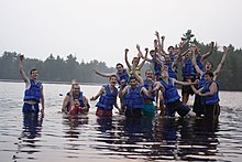 Attendees of summer camps often enjoy outdoor activities. This photo of a YMCA camp shows campers in a lake. BCCYMCA Waterfront.JPG