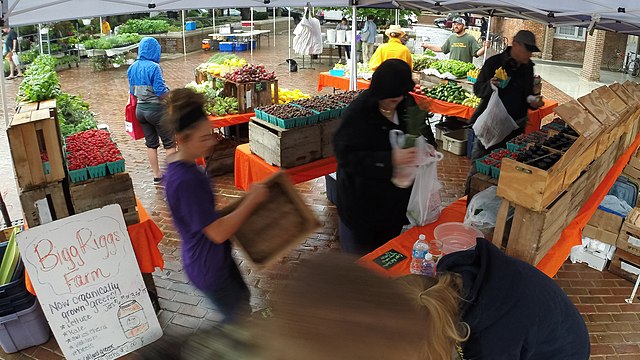 A farmers' market offering food produced by community-supported agriculture that is also delivering online orders