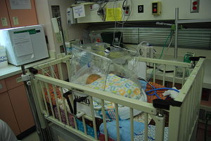 An infant placed under an oxygen tent Caleb David.jpg