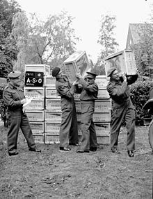 Delivery of 500,000 free cigarettes from the Overseas Tobacco League to the 5th Canadian Armoured Division, Groningen, Netherlands; (L-R): Captain J.F. Yeddeay, Lorne Scots; Senior Supervisor W.R. Blythman and Supervisor R.R. Jacks, both of Canadian Legion Auxiliary Services Canadian cigarettes groningen.jpg