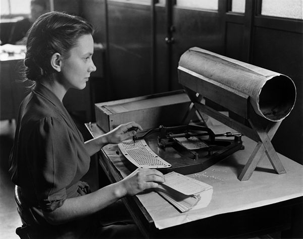 A woman with a Hollerith pantograph punch. The keyboard is for the 1940 U.S. census population card.