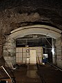 Partially lined cavern (notice the rocks above the concrete ceiling) and ring laser equipment.