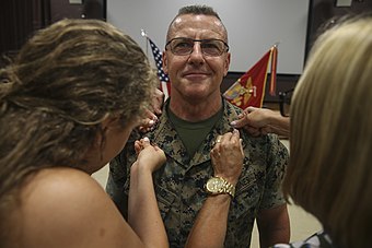LtGen Robert F. Hedelund, commanding general, II Marine Expeditionary Force, is pinned by family members during his promotion ceremony on July 14, 2017.