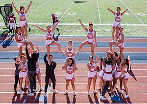 Cheerleading stunts can have different levels of complexity (Cornell University) Cornell University cheerleaders at Cornell-Penn game, 2019.jpg