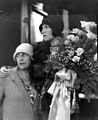 Dolores Del Rio with her mother on the steps of a train, holding a bouquet of roses (4951163325).jpg