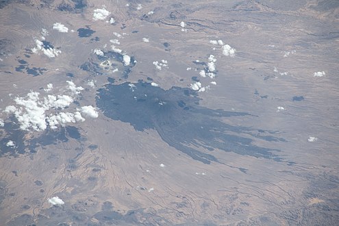 Pic Toussidé with clouds and shadows of clouds, caldera Trou au Natron photo with lake (1)