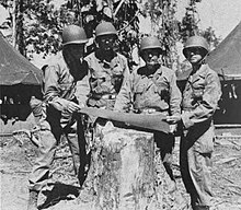 Division's first wartime commander, MG John C. Persons (center) discussing the situation over the map with his officers at New Guinea in July 1944.Left to right: commanding officer of 167th Infantry Regiment, Colonel LeRoy S. Graham; Division's Artillery commander Brigadier general Sumter L. Lowry; MG Persons; and Division's assistant commander Brigadier general Joseph C. Hutchinson. John C. Persons with his officers over the map in Pacific 1944.jpg