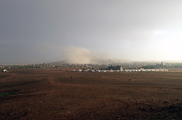 Kobanî during the bombardment of ISIL targets by US-led forces. Photo taken from Turkish-Syrian border at Suruç, Turkey showing refugee camp in the mi