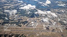 Aerial view of McChord Field from the east, with the rest of Joint Base Lewis–McChord in the left background, and the city of Lakewood in the right background