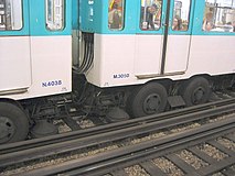 Paris Métro. The guiding rails of the rubber-tyred lines also function as current conductors. The horizontal contact shoe is between the pair of rubber wheels.