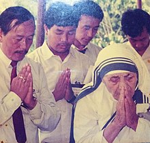 Mother Teresa at Borduria praying with James Lowangcha Wanglat, former Home Minister of Arunachal Pradesh. Mother Teresa praying at Borduria, a Nocte village.jpg