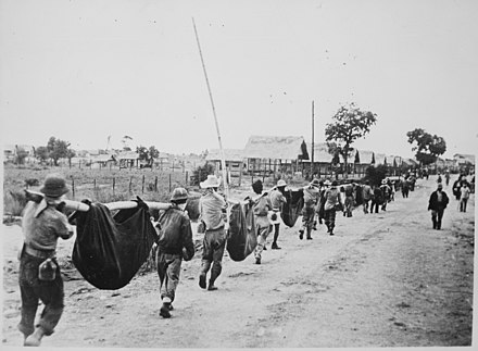 A burial detail of American and Filipino POWs killed during the Bataan Death March, 1942.