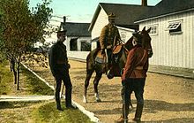 Mounted police officers at Fort Macleod, c.1917, (l to r) in service order, patrol and full dress uniform Postcard of Royal North West Mounted Police officers at the Macleod, Alberta barracks.jpg