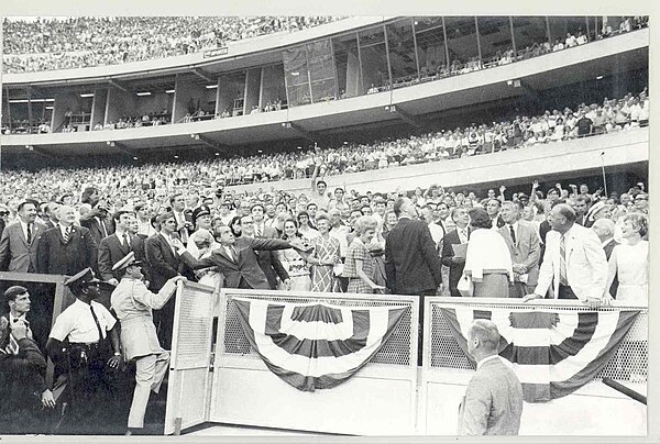 Nixon throwing a ball to the fans.