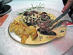 A beef steak served with peppercorn sauce prepared with five types of peppers Steak with five pepper sauce.jpg