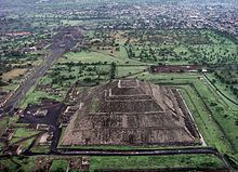 This aerial view of what was once downtown Teotihuacan shows the Pyramid of the Sun, Pyramid of the Moon, and the processional avenue serving as the spine of the city's street system. Teotihuacan 2012-09-28 00-07-11.jpg