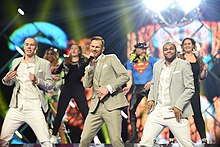 Hugo (center) performing at MGP 2018 Tom Hugo Melodi Grand Prix 2018.jpg