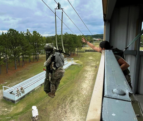 A paratrooper with E Battery, 3rd Battalion, 4th Air Defense Artillery Regiment practices jumping from a 34-foot tower with the FIM-92 Stinger and the new "weapon exposed apparatus" US Army Paratrooper Jumps with FIM-92 from 34 foot tower.png