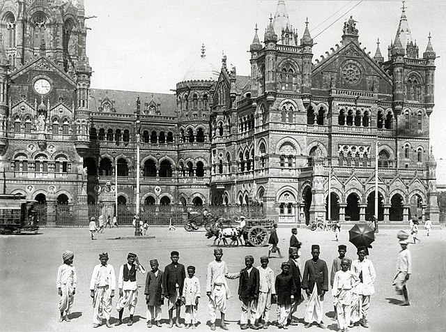 A photo of Victoria Terminus from 1910. Note the seated statue in the canopy under the clock