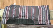 A modern western saddle pad, with blanket design on top, fleece underneath, and felt or foam padding on the inside WesternPad.jpg