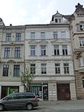 Apartment building with shop front, in a closed area