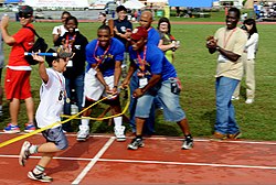 A Special Olympics (SO) athlete crosses the finish line after completing the last leg of a 400 meter relay race during the Kadena Air Base SO event in Okinawa, Japan, Nov 111105-F-FL863-002.jpg