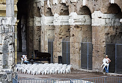 A young female pianist rehearsing for a night concert takes a break in the Teatro di Marcello, Rome, Italy