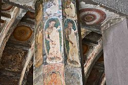 Later painting with devotional figures, on pillars and ceiling