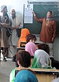 An Afghan girl and student of the newly opened Shar-e Sara Girls School is given an eye examination from a coalition forces' ophthalmologist in Zabul province, Afghanistan, Sept 110913-N-AT856-046.jpg