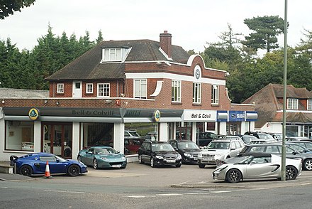 The Bell & Colvill car dealership is a landmark by the roundabout on the cross-county route past the village