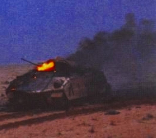 Wrecked Bradley IFV K-12 burns after being hit by Iraqi tank fire during the first stages of the battle