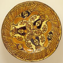 Charger with Charles II in the Boscobel Oak, English, c. 1685. The plate's diameter is 43 cm; such large plates, for display rather than use, take slip-trailing to an extreme, building up lattices of thick trails of slip. Charger of Charles II in the Boscobel Oak LACMA M.86.151.jpg