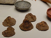 Conical loaves of bread as grave goods exactly as laid out in the Great Tomb, North Necropolis, Gebelein, 5th Dynasty (Old Kingdom), 2435-2305 BC. Excavations by Ernesto Schiaparelli, 1911. Egyptian Museum, Turin, S. 14051-14055 Conical loaves of bread, Gebelein, 5th Dynasty c 2400 BC.jpg