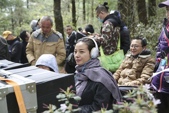 Production still. On 8 April 2016, director Zhao Wei (center) filming her second feature.