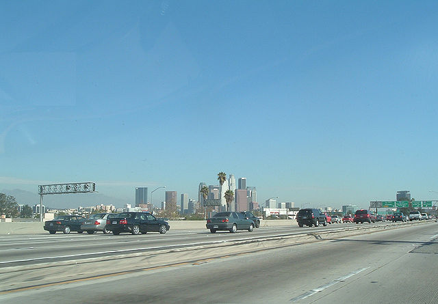 Downtown Los Angeles skyline as seen from the freeway. A slight (smaller than usual rush hour) traffic jam is ahead.