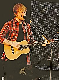 Ed Sheeran was the dominant artist of 2017, achieving a total of 11 UK top 10 singles during the year, two of which topped the chart. "Shape of You" became both the longest-reigning number-one single and the best-selling single of the year. Ten of the sixteen tracks from his third studio album / reached the top 10. The remix of "Perfect" featuring Beyonce helped the song to become the year's Christmas number-one single. Ed Sheeran, V Festival 2014, Chelmsford (14788750738).jpg